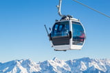 Eine Gondelbahn im Winter in den verschneiten Alpen Bergen.